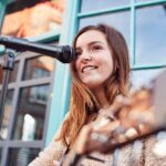 female-musician-busking-playing-acoustic-guitar-QGPZ2UP.jpg